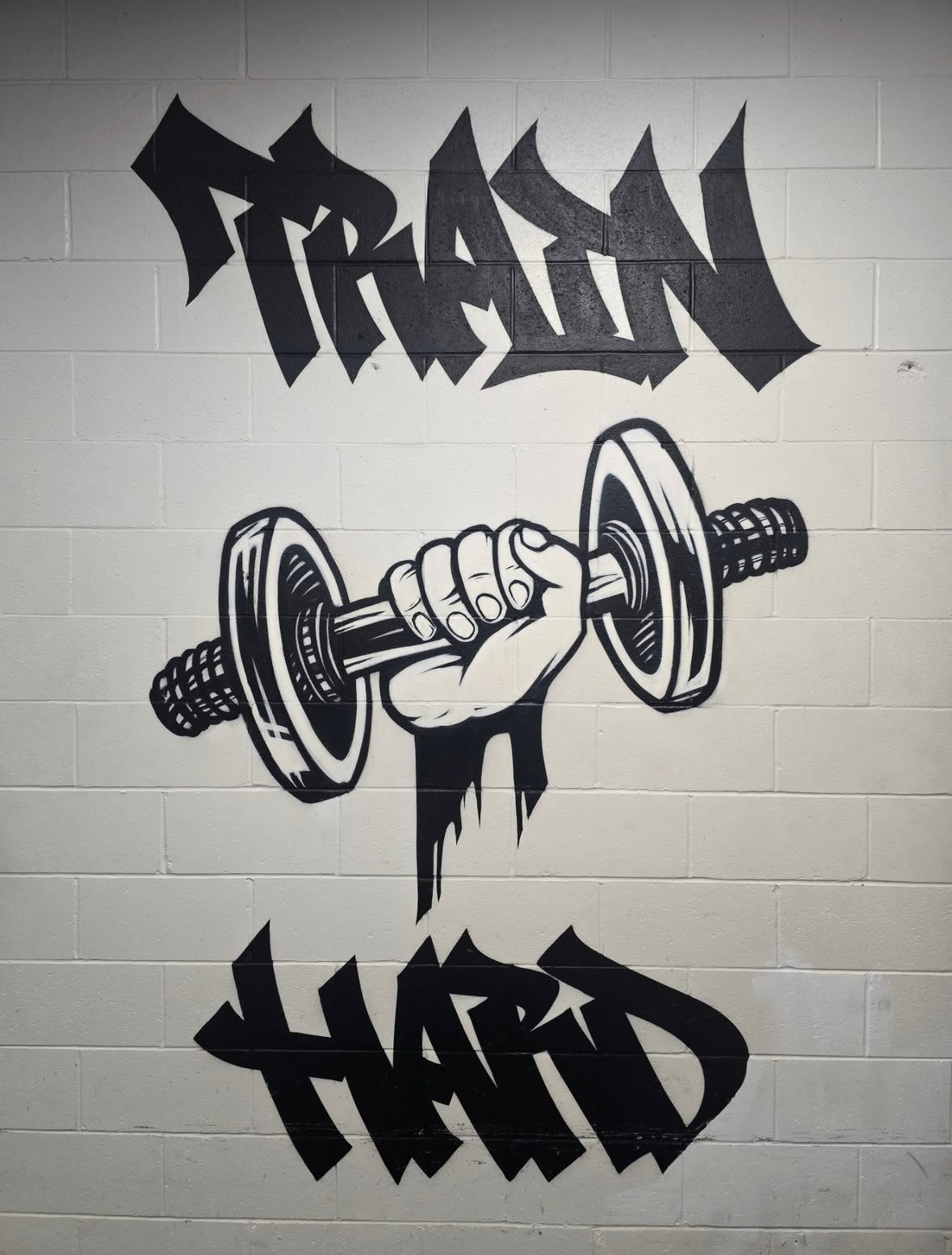 TRAIN HARD mural inside Fraser Valley Fitness